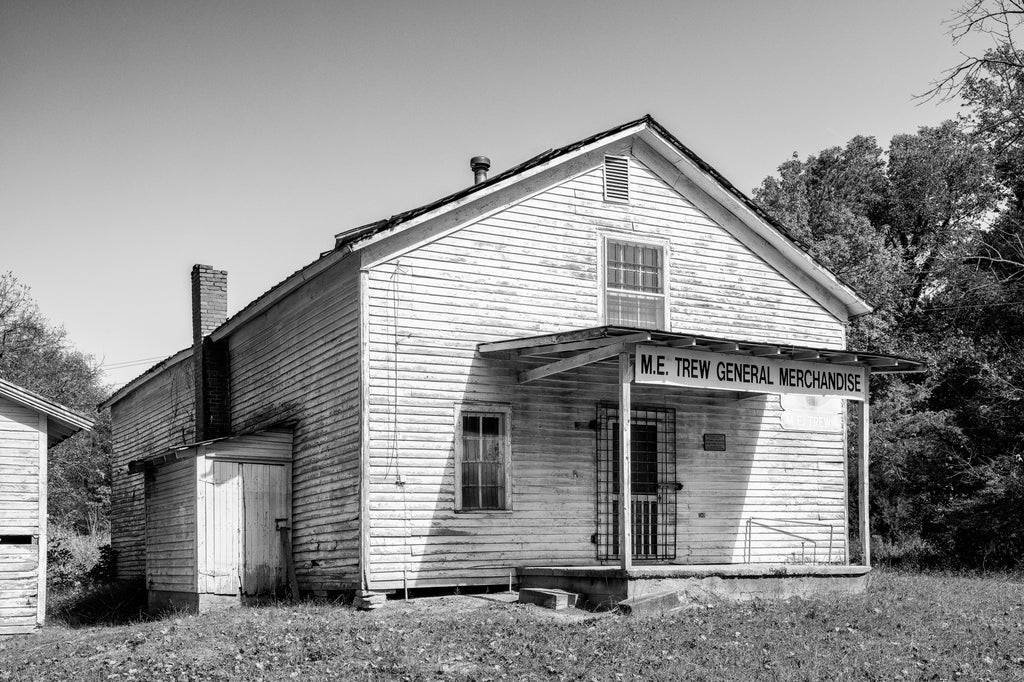 Black and white photograph of the now vacant Trew General Merchandise Store in rural East Tennessee. The first building was constructed in 1890 by J.W. Trew, and the second opened in 1903. The store was managed by M.E. Trew from 1925 until his death in 1996, when the store was permanently closed.