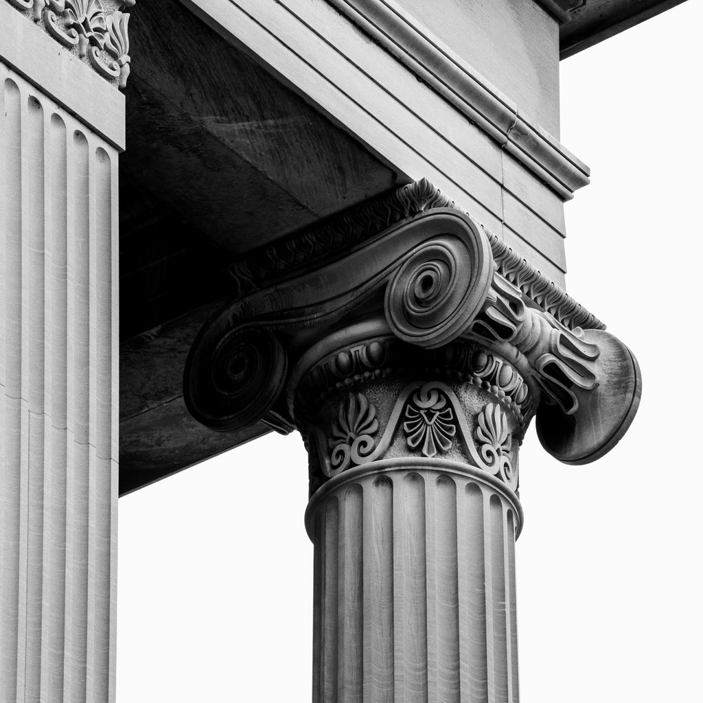 Black and white detail photograph of a Greek Revival column on the outside of the Tennessee State capitol building in Nashville, Tennessee. (Square format)