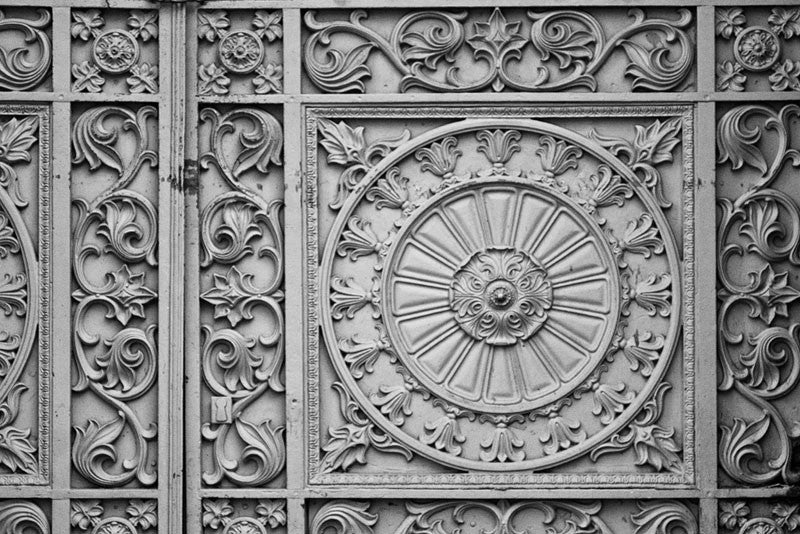 Black and white architectural detail photograph of beautiful, decorative metalwork flourishes in the French Quarter of New Orleans.