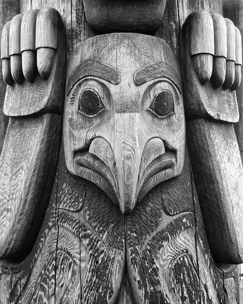 Black and white detail photograph of the bird figure on the totem pole that stands on the Seattle waterfront.