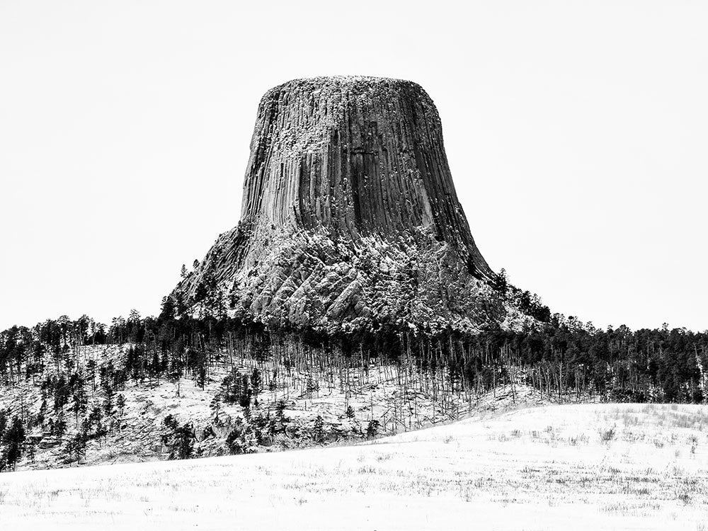 Black and white landscape photograph of Devil's Tower, Wyoming in winter.