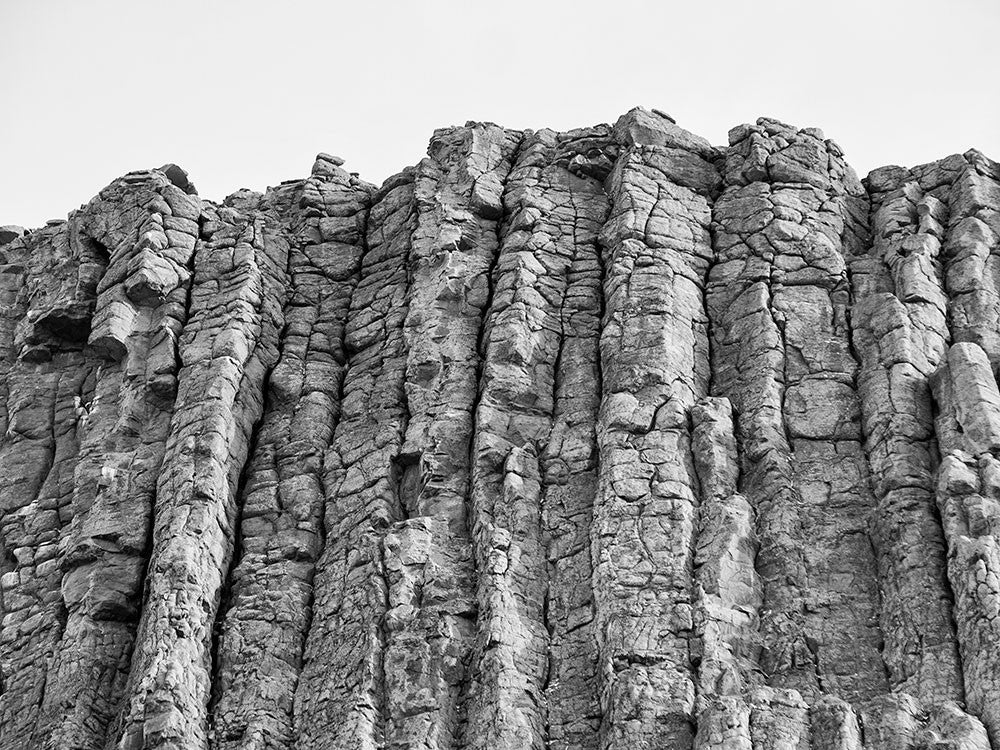 Black and white photograph of the rough, rocky top edge of Devil's Tower, Wyoming.