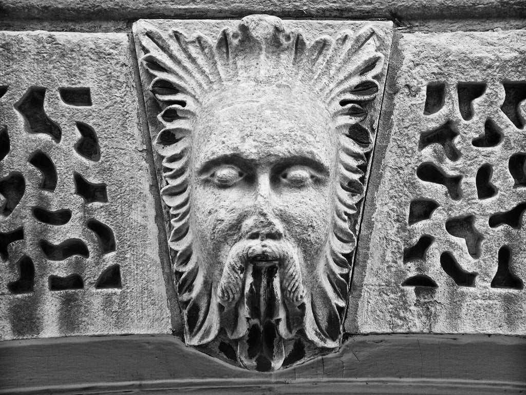 Black and white photograph of the carved stone face of Aeolus the God of the Winds on the old Bank of Milwaukee Building