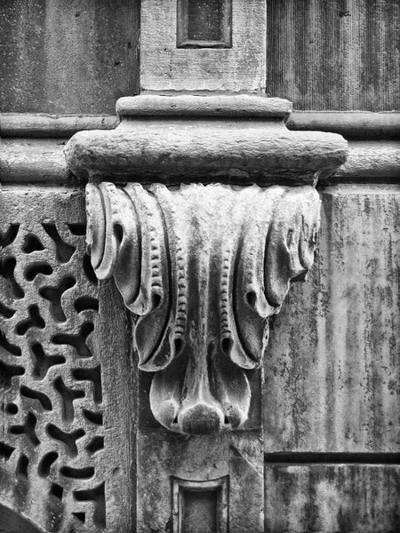 Black and white photograph of a carved stone architectural element on the old Bank of Milwaukee Building (also called the Insurance Exchange Building and the Grand Avenue Club) in downtown Milwaukee