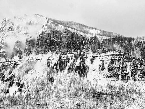 Black and white landscape photograph of Wyoming mountains in snow.