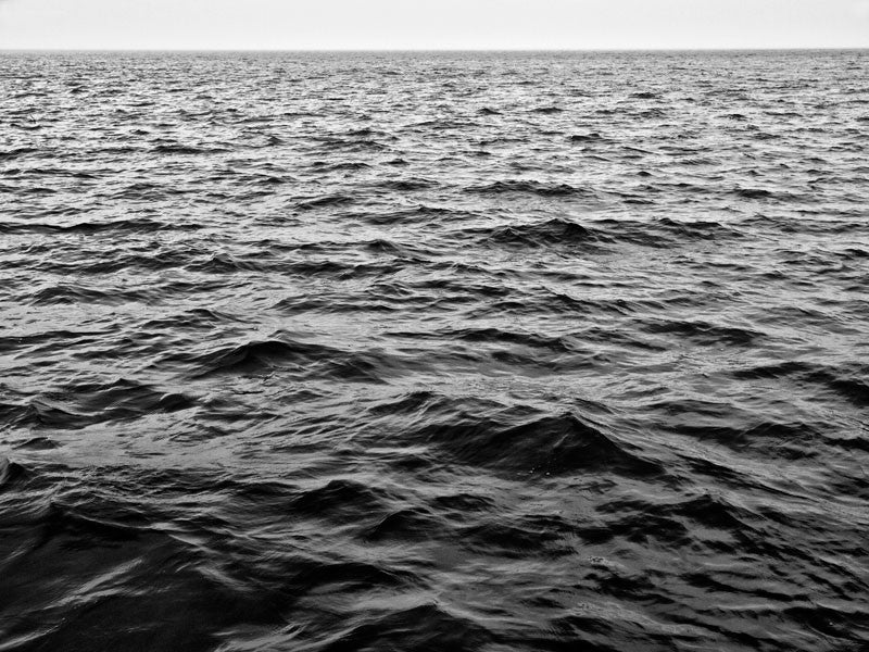 Black and white photograph of rhythmic waves in early morning light on Madison's beautiful Lake Mendota. 