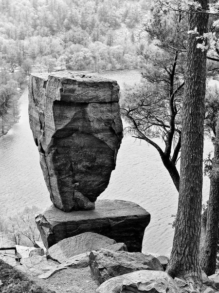 Black and white landscape photograph of the famous Balanced Rock overlooking Devil's Lake in Wisconsin. Devil's Lake was formed naturally by the action of glaciers during the last ice age.