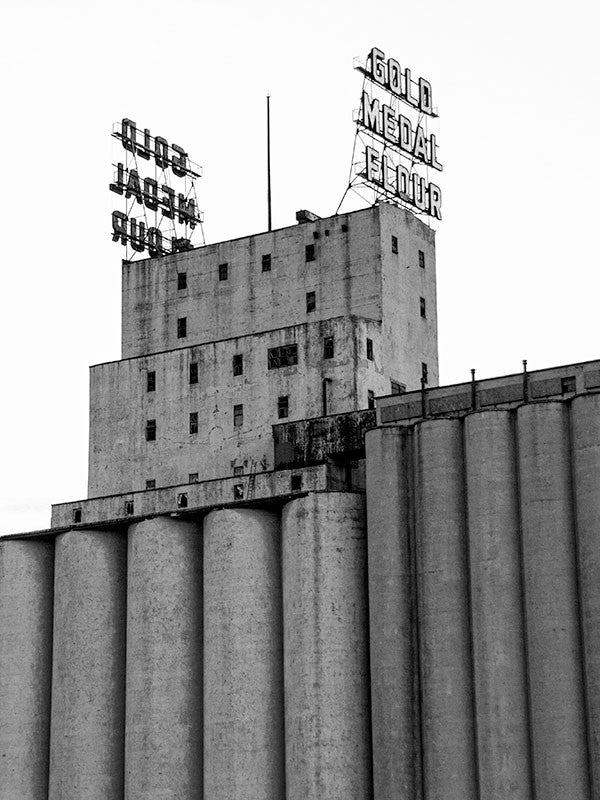 Black and white photograph of the Gold Medal grain silos in downtown Minneapolis.