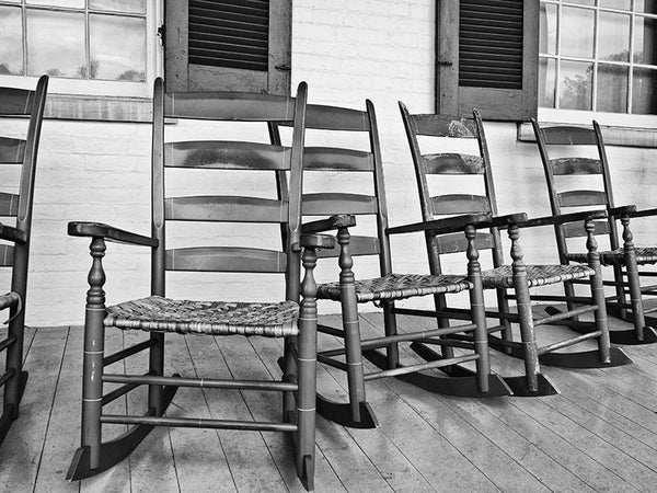 Black and white photograph of rocking chairs on the back porch at the historic Carnton house in Franklin, Tennessee.