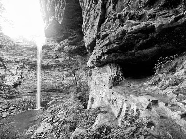 Black and white landscape photograph the cave above the rocky pool at the base of Ozone Falls, Tennessee.