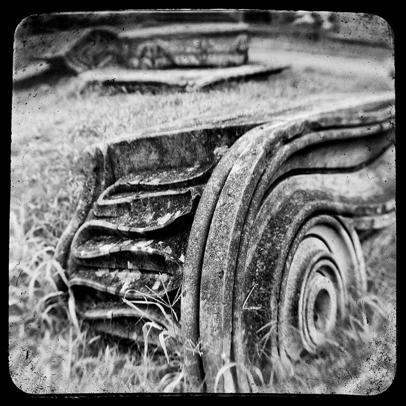 Black and white through-the-viewfinder photograph of an antique Ionic column fragment laying in the grass in Nashville. Through-the-viewfinder (TTV) photography is an alternative style of photography where a camera is focused though the view finder of another camera -- usually a vintage or antique model. This technique gives a uniquely distorted quality.