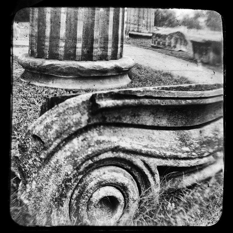Black and white through-the-viewfinder photograph of an antique Ionic column fragments in Nashville. Through-the-viewfinder (TTV) photography is an alternative style of photography where a camera is focused though the view finder of another camera -- usually a vintage or antique model. This technique gives a uniquely distorted quality.