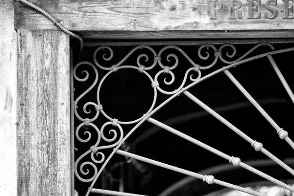 Black and white architectural detail photograph ironwork over the entrance to Preservation Hall, in the French Quarter of New Orleans.