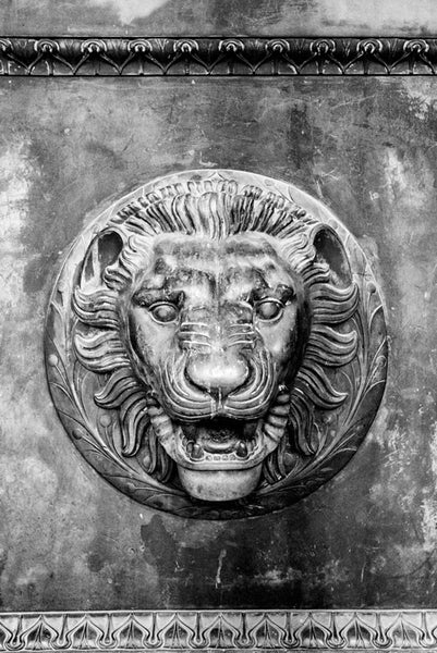 Black and white photograph of a lion head figure on one of the the huge bronze doors on the entrance to Nashville's replica of the Parthenon in Athens. Each of the four double-doors is 24 feet tall, one foot thick, and weighs seven and a half tons.