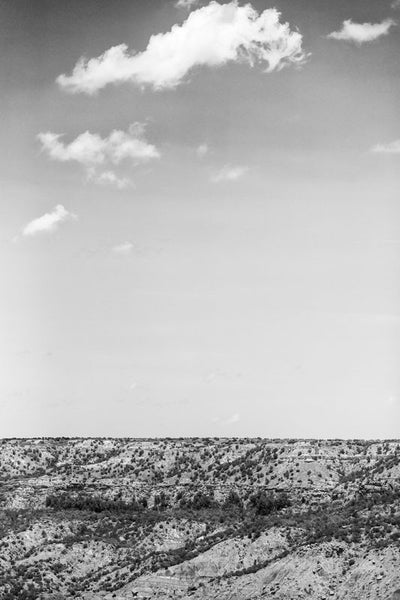 Black and white photograph of the big sky over the rugged landscape of Palo Duro Canyon, in the Texas Panhandle.