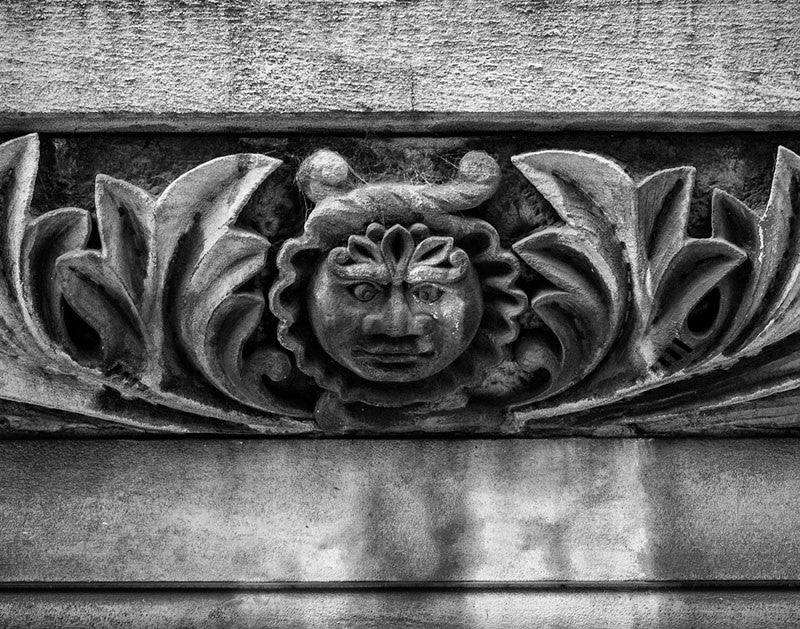Black and white architectural detail photograph of a strange face carved into the stonework of the historic Utopia Hotel in downtown Nashville. The hotel opened in 1891 to accommodate visitors in town for the Tennessee Centennial Exposition.
