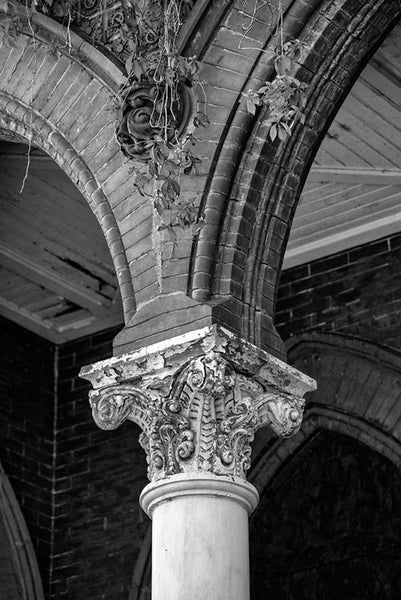 Black and white photograph of Louisville's abandoned Quinn Chapel, a historic church falling into ruin but still quite beautiful and evocative with it's peeling, white columns, arches, and creeping ivy.