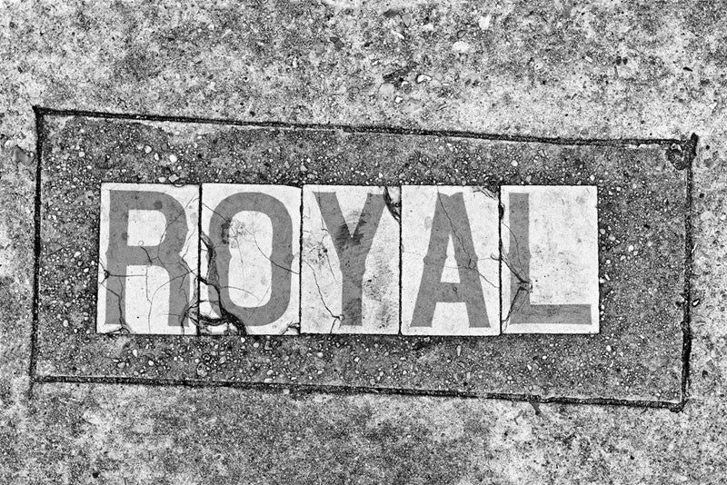 Black and white fine art photograph of the word "Royal" in a sidewalk in the French Quarter of New Orleans, Louisiana. 